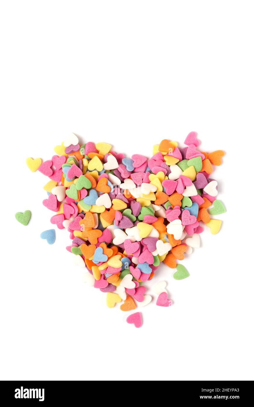 Multi-colored heart-shaped pastry topping in heart form on white background, minimalistic saint valentine`s day greeting card Stock Photo